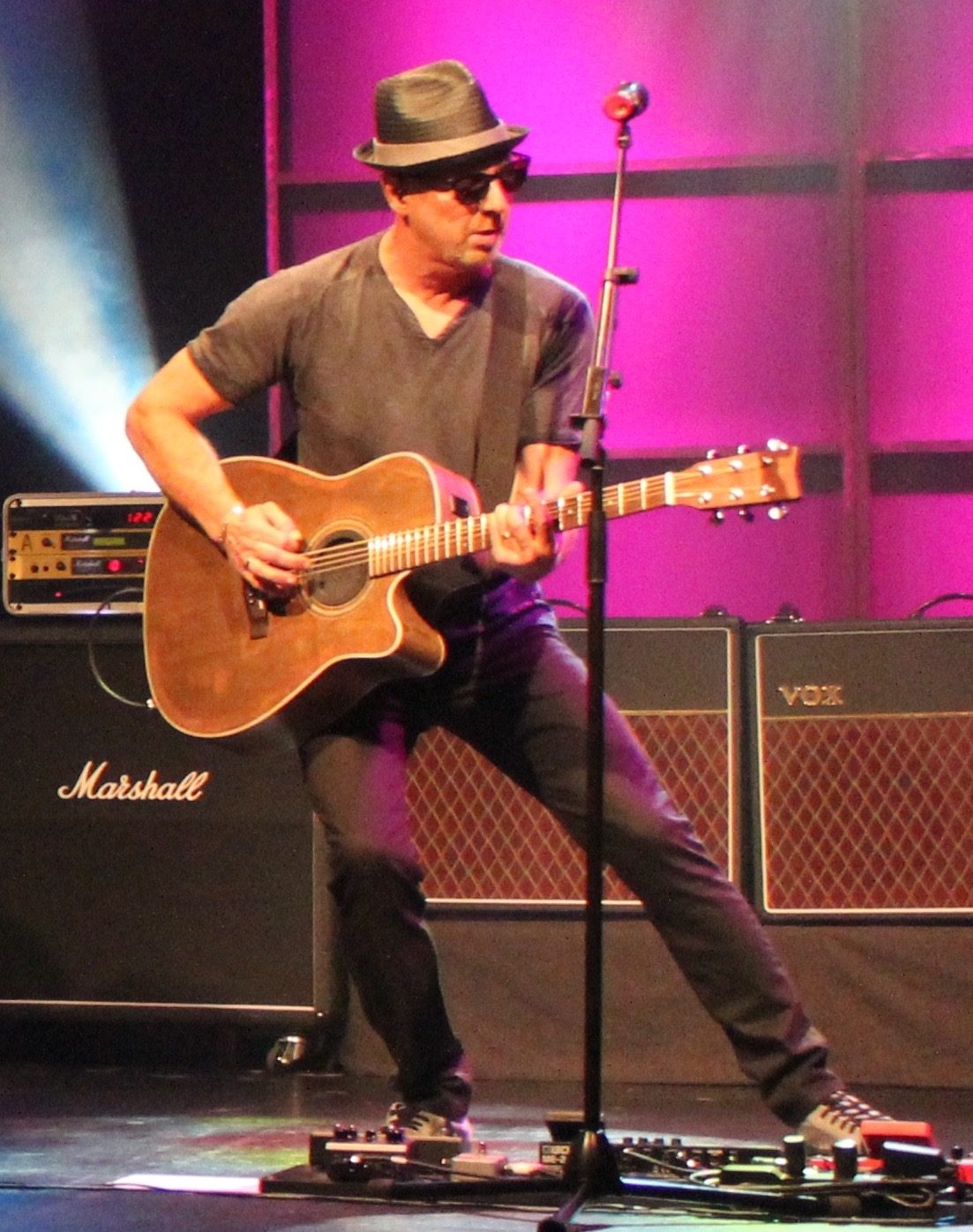 Jim Rhodes performing live with an acoustic guitar