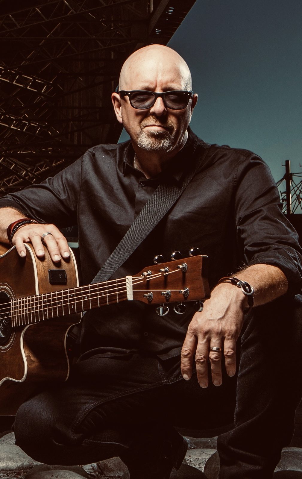 Portrait of Jim Rhodes with his acoustic guitar